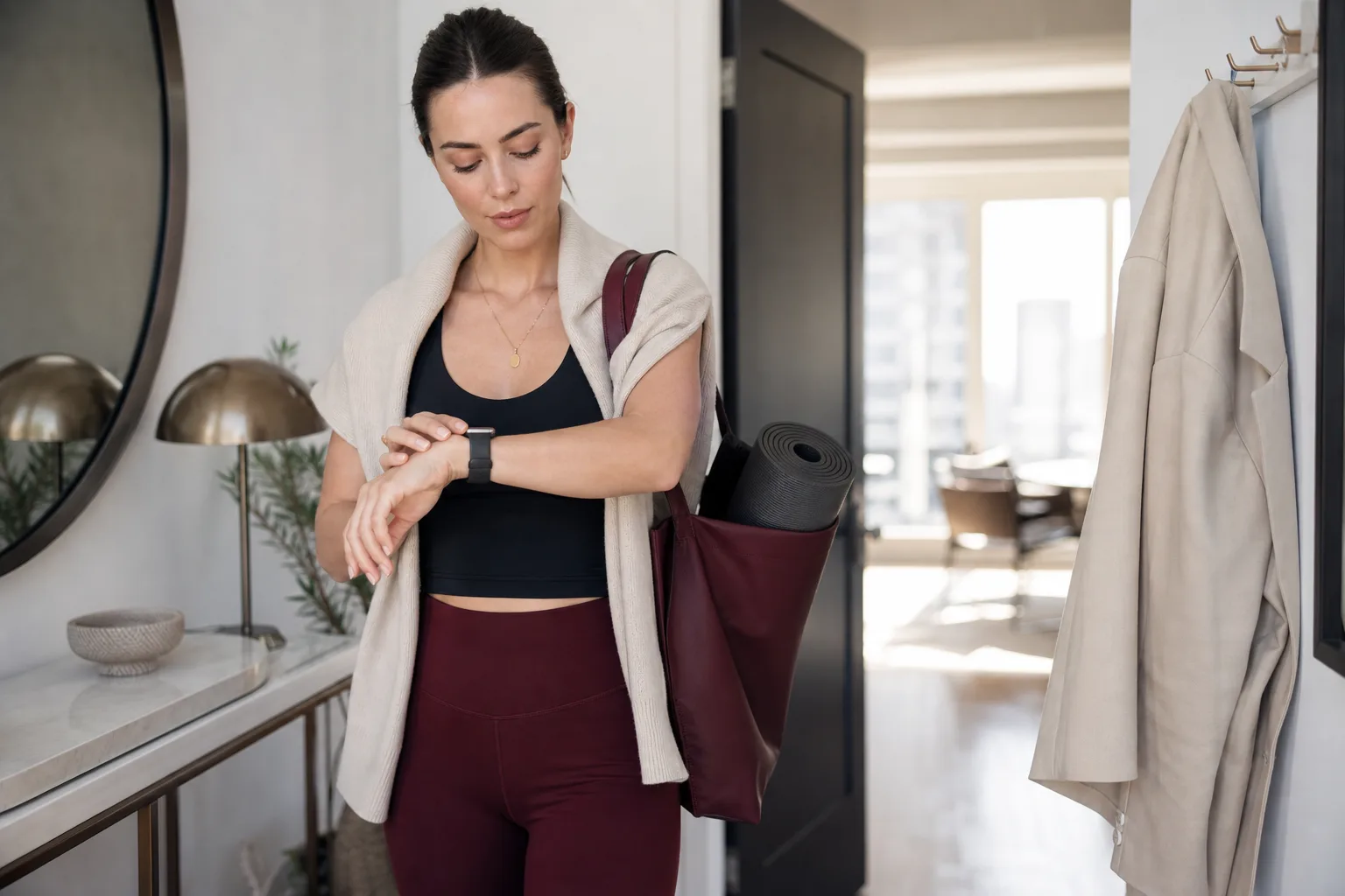 Woman checking a slim smartwatch before a Pilates class